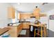 Well-lit kitchen features wooden cabinetry, countertops, and a functional island with barstool seating at 1184 Fern Ave, Orlando, FL 32814