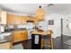 Functional kitchen features light wood cabinets, black countertops, and a cozy eating area at 1184 Fern Ave, Orlando, FL 32814