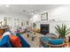Spacious living room with a fireplace, ceiling fan, and modern decor at 1184 Fern Ave, Orlando, FL 32814