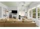 Bright living room boasts a large tan couch, natural light from large windows, and unique ceiling design at 1184 Fern Ave, Orlando, FL 32814