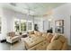 Light-filled living room with a comfortable sofa, large windows, and a ceiling fan at 1184 Fern Ave, Orlando, FL 32814