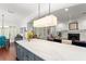 Open-concept kitchen and living space featuring a large island, fireplace, and bright, natural light at 1184 Fern Ave, Orlando, FL 32814