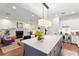 Open-concept kitchen and living area with a large island, modern fireplace, and seamless flow for entertaining at 1184 Fern Ave, Orlando, FL 32814