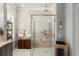 Modern shower boasts stone tile, glass surround, rainfall showerhead, and sleek design at 1184 Fern Ave, Orlando, FL 32814