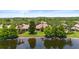 Aerial view of a home nestled among lush trees reflecting in the lake at 11863 Delfina Ln, Orlando, FL 32827
