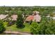 Aerial view of a home, highlighting its lush landscaping and serene lakeside setting at 11863 Delfina Ln, Orlando, FL 32827