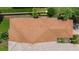 Aerial view of the home showcasing the roof, landscaping, and surrounding greenery at 11863 Delfina Ln, Orlando, FL 32827