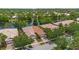 Aerial view of a lakeside home featuring well-maintained landscaping at 11863 Delfina Ln, Orlando, FL 32827