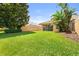 Expansive backyard with lush green grass and tropical landscaping at 11863 Delfina Ln, Orlando, FL 32827