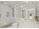 Bathroom featuring a sleek, glass-enclosed shower with modern fixtures and stone flooring at 11863 Delfina Ln, Orlando, FL 32827