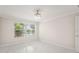 Bright bedroom features tile floors, neutral walls, and a window with a view of a lake at 11863 Delfina Ln, Orlando, FL 32827
