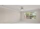 Bright bedroom featuring marble floors, crown molding, and a view to the water at 11863 Delfina Ln, Orlando, FL 32827