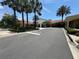 A grand entrance welcomes residents and guests to the clubhouse with beautiful landscaping and palm trees at 11863 Delfina Ln, Orlando, FL 32827