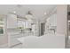 Bright kitchen featuring white countertops, appliances, and mosaic backsplash illuminated by pendant lighting at 11863 Delfina Ln, Orlando, FL 32827