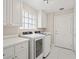 Bright laundry room with white cabinets and modern appliances at 11863 Delfina Ln, Orlando, FL 32827