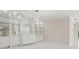 Bright living room with modern built-in shelves, cabinets, elegant light fixtures, and a white tile floor at 11863 Delfina Ln, Orlando, FL 32827