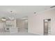 Open-concept living space with a kitchen, dining area, and elegant light fixtures at 11863 Delfina Ln, Orlando, FL 32827