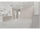 Bright living room featuring marble floors and modern chandelier lighting at 11863 Delfina Ln, Orlando, FL 32827