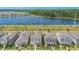 Aerial view of new construction community with lush green surroundings and a beautiful lake view at 11944 Sunsail Ave, Orlando, FL 32832