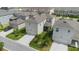 Aerial view of a two-story home showcasing a screened-in patio, a two-car garage and well-maintained lawn at 11944 Sunsail Ave, Orlando, FL 32832