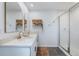 Modern bathroom featuring double vanity, gold fixtures, open shelving, and glass-enclosed walk-in shower at 11944 Sunsail Ave, Orlando, FL 32832