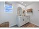 Stylish bathroom with a double sink vanity, modern fixtures, and a window providing natural light at 11944 Sunsail Ave, Orlando, FL 32832