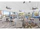 Clubhouse with ceiling fans, plenty of seating, and large windows overlooking the community pool and splash pad at 11944 Sunsail Ave, Orlando, FL 32832