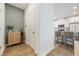 Open entryway with hall cabinet, white doors, and a view to the bright kitchen at 11944 Sunsail Ave, Orlando, FL 32832