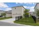 Two-story home featuring a two-car garage, a black metal fence, and green grass in the front yard at 11944 Sunsail Ave, Orlando, FL 32832