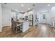 Open kitchen with white cabinets, a breakfast bar, and a view into the entryway at 11944 Sunsail Ave, Orlando, FL 32832