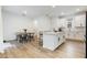 Bright kitchen and dining area featuring white cabinets, an island, and modern appliances at 11944 Sunsail Ave, Orlando, FL 32832