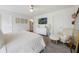 Bright main bedroom with ensuite bathroom access, large bed, and neutral decor at 11944 Sunsail Ave, Orlando, FL 32832