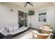 Comfortable screened patio with ceiling fan and outdoor seating area with a television at 11944 Sunsail Ave, Orlando, FL 32832