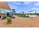 Community playground with multiple slides and playground equipment, cushioned by woodchips and shaded by canopies at 11944 Sunsail Ave, Orlando, FL 32832