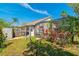 Fenced backyard with lush greenery, a storage shed, and a screened-in patio at 131 Country Creek Ln, Kissimmee, FL 34746