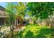 Private backyard featuring mature trees, lush lawn, and a pathway at 131 Country Creek Ln, Kissimmee, FL 34746