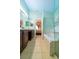 A bright bathroom with a large tub, glass shower, and dual sinks at 131 Country Creek Ln, Kissimmee, FL 34746