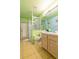 Bright bathroom with a glass-enclosed shower, linoleum flooring and a vanity with a neutral-toned wooden cabinet at 131 Country Creek Ln, Kissimmee, FL 34746