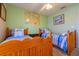 A lovely bedroom with a ceiling fan, two twin beds, and a decorative world map at 131 Country Creek Ln, Kissimmee, FL 34746