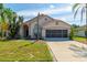 Welcoming single-Gathering home with a manicured lawn and an attached two-car garage at 131 Country Creek Ln, Kissimmee, FL 34746