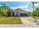 Inviting single-Gathering home featuring a well-kept lawn and a convenient two-car garage at 131 Country Creek Ln, Kissimmee, FL 34746