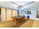 A fun game room features a pool table, laundry facilities, and a white brick wall at 131 Country Creek Ln, Kissimmee, FL 34746