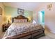A beautifully decorated main bedroom featuring a large wooden bed frame and bedside tables at 131 Country Creek Ln, Kissimmee, FL 34746