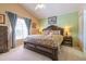 A beautifully decorated main bedroom with a wooden bed frame and natural light at 131 Country Creek Ln, Kissimmee, FL 34746