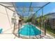 Sparkling swimming pool surrounded by a screened enclosure, offering privacy and enjoyment at 131 Country Creek Ln, Kissimmee, FL 34746