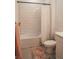 Bathroom features a tile-surround tub and shower, modern fixtures and decorative rug at 1340 Blue Stem Ln, Winter Park, FL 32792