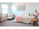 A cozy bedroom with framed leaf prints over a bed with fluffy pillows and throw blanket at 1340 Blue Stem Ln, Winter Park, FL 32792