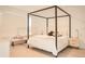 Minimalist primary bedroom with a four-poster bed and light wood floors at 1340 Blue Stem Ln, Winter Park, FL 32792
