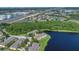Aerial view captures neighborhood and community by a lake, surrounded by lush greenery at 13480 Applerose Ln # 19, Orlando, FL 32824