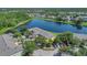 Scenic aerial view of complex with a lake surrounded by lush trees and well-maintained lawns at 13480 Applerose Ln # 19, Orlando, FL 32824